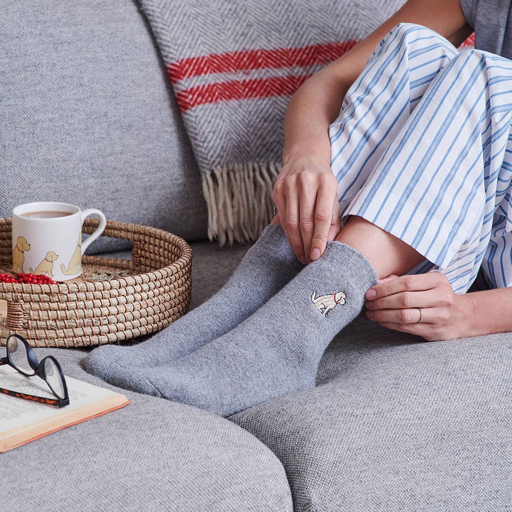 Person wearing dog embroidered wool socks
